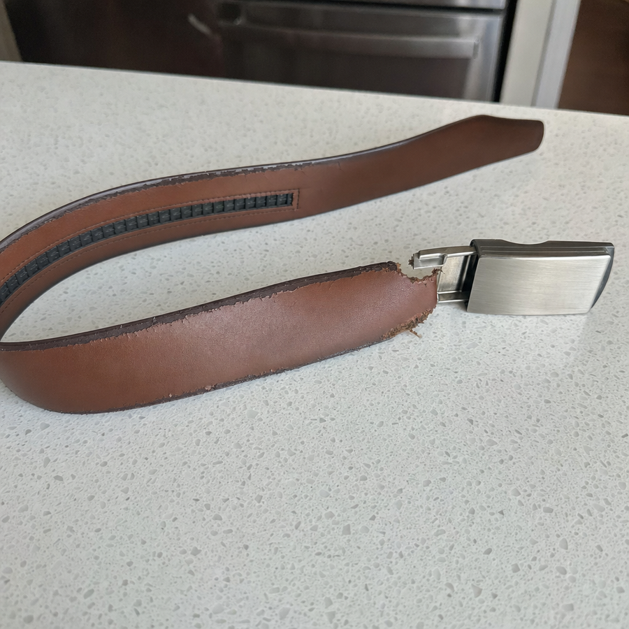 A cheap ratchet belt torn off at the buckle clamp